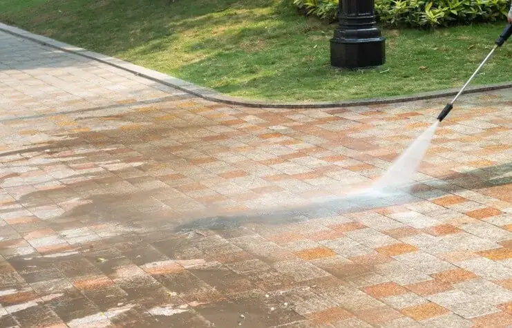 Block paving being pressure washed