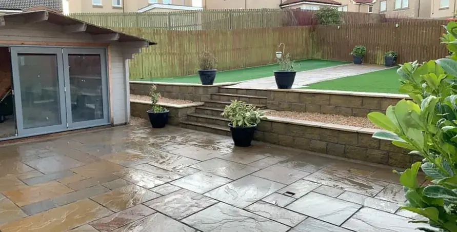 Paved patio beside a garden lawn
