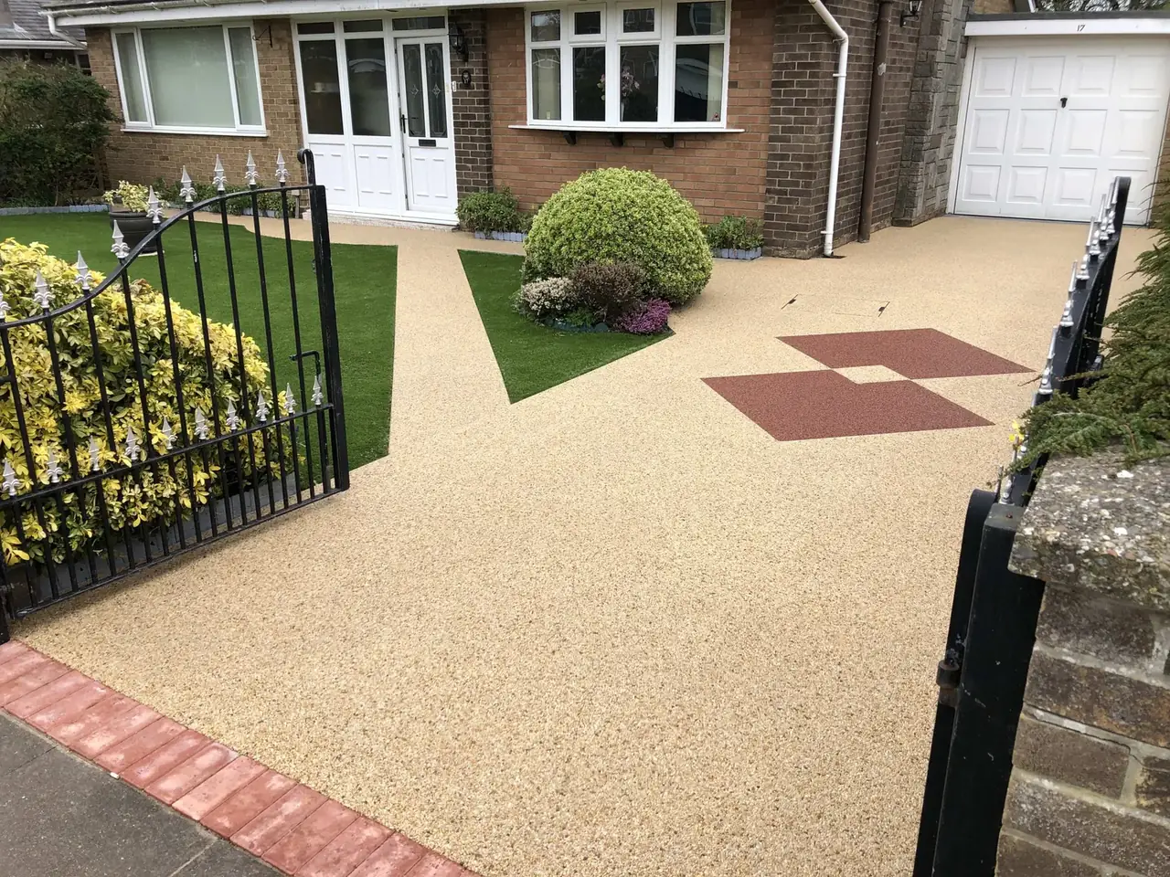 Resin bound driveway with a diamond inlay behind black gates