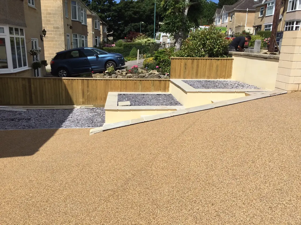 Finished resin driveway with steps and a raised planter