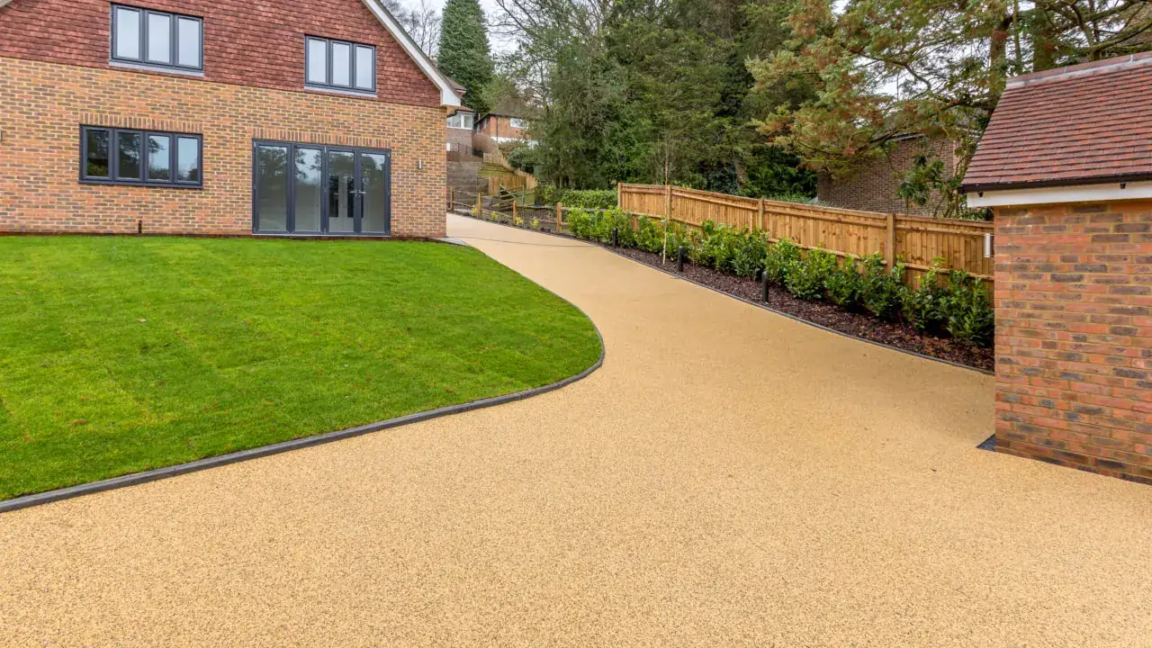 Resin bound driveway beside a wet lawn
