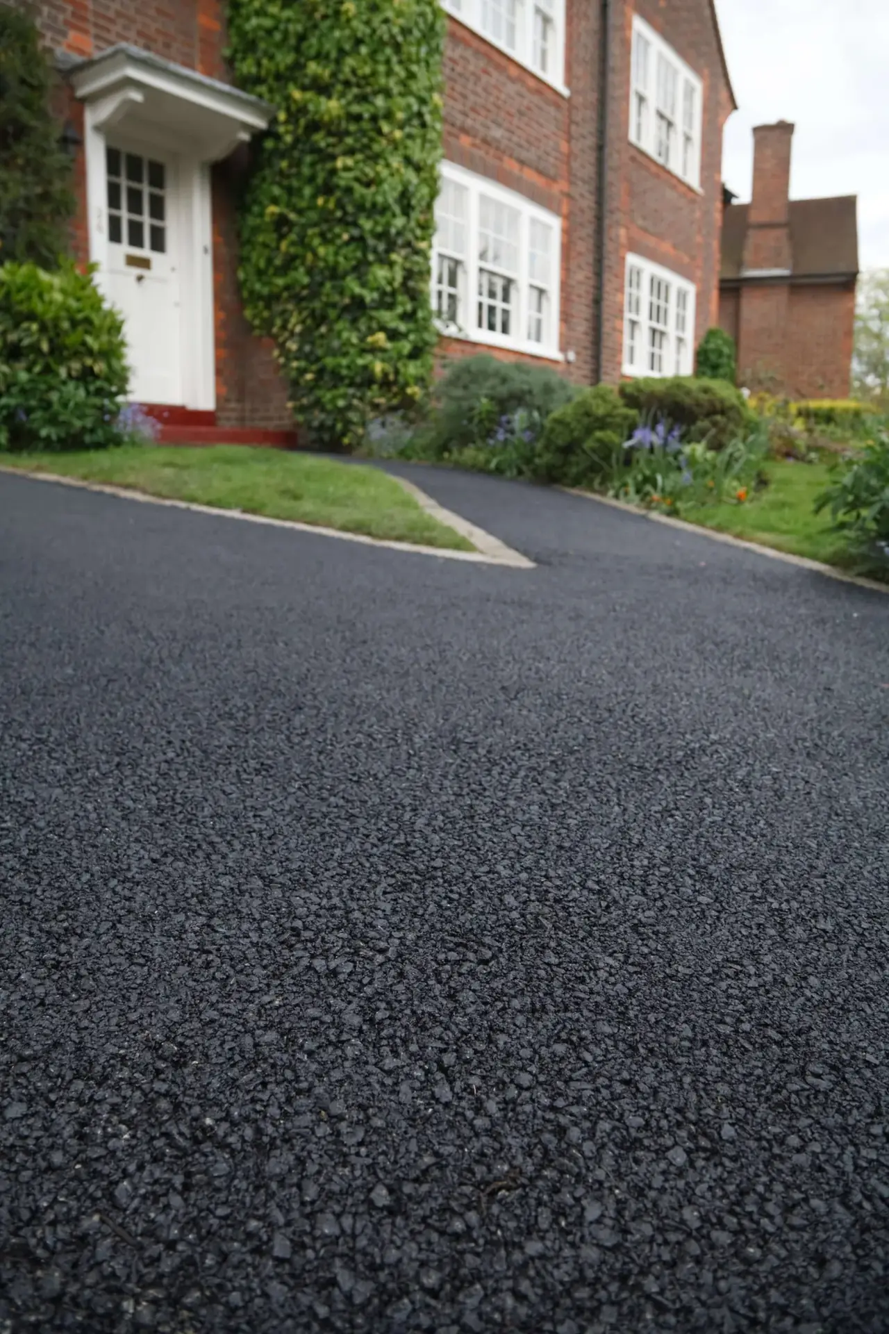 Long tarmac driveway running up a slope