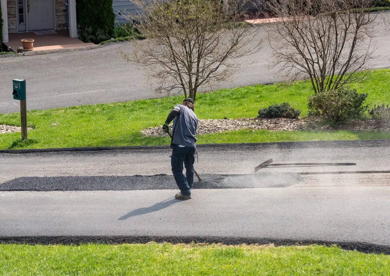Tarmac being raked and laid on a new driveway